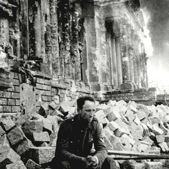 Um soldado alemão senta sobre as ruínas do Palácio do Reichstag no dia 9 de maio de 1945. (Créditos: Laski Diffusion/Getty Images)