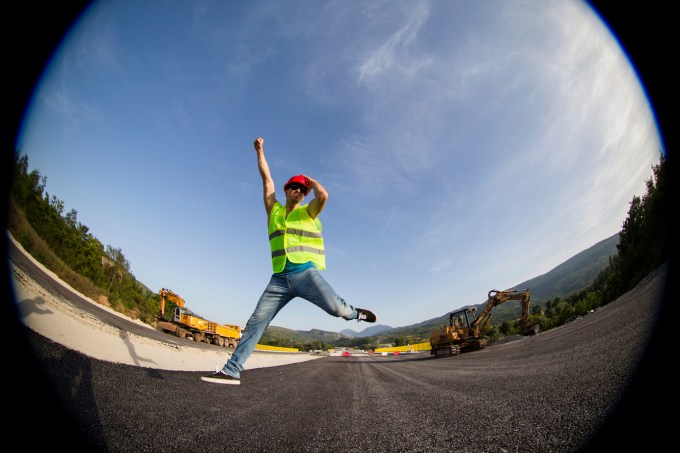 Construction worker smiling and jumping